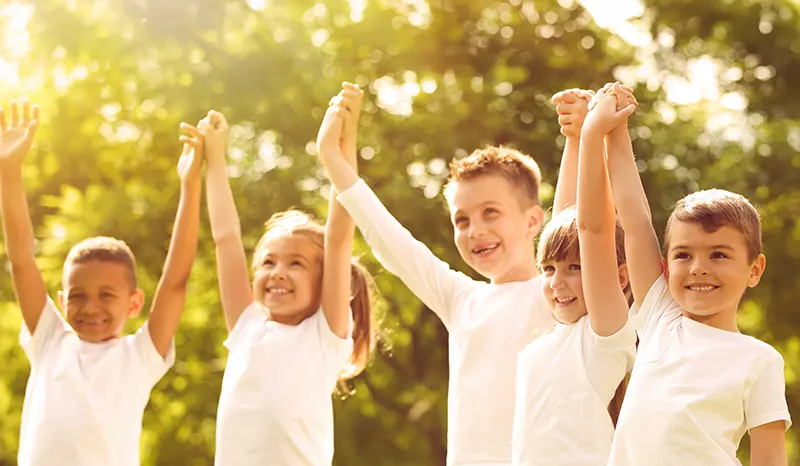 a group of kids having fun and holding hands