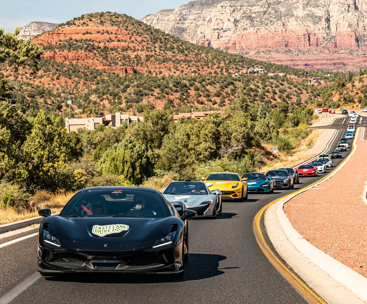 Cars driving on a deser road during a Fast Lane Drive event